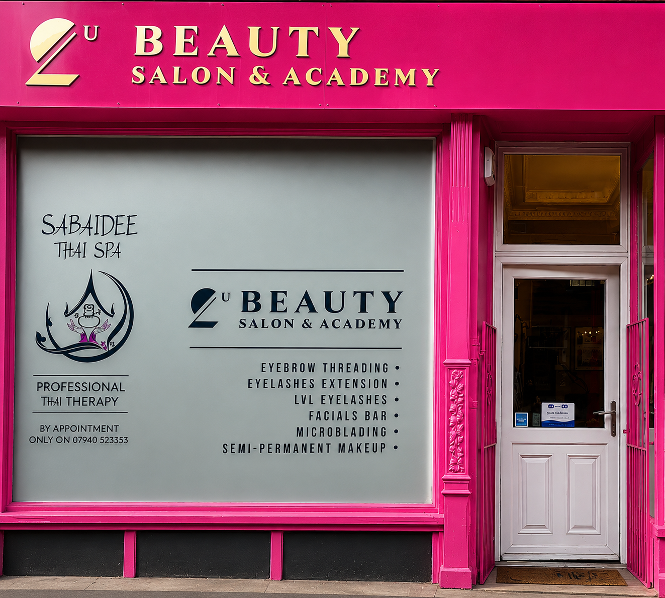 The bright pink 2U Beauty Salon shopfront on Lochrin Buildings, with Sabaidee Thai Spa's name and logo in the left-hand window and the salon's white entrance door to the right.